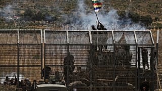 İsrail kontrolündeki Golan Tepeleri'ndeki Majdal Şems kasabasından görüldüğü üzere, İsrail-Suriye sınırına yakın Suriyeli Dürzi protestosu, 16 Temmuz 2025.