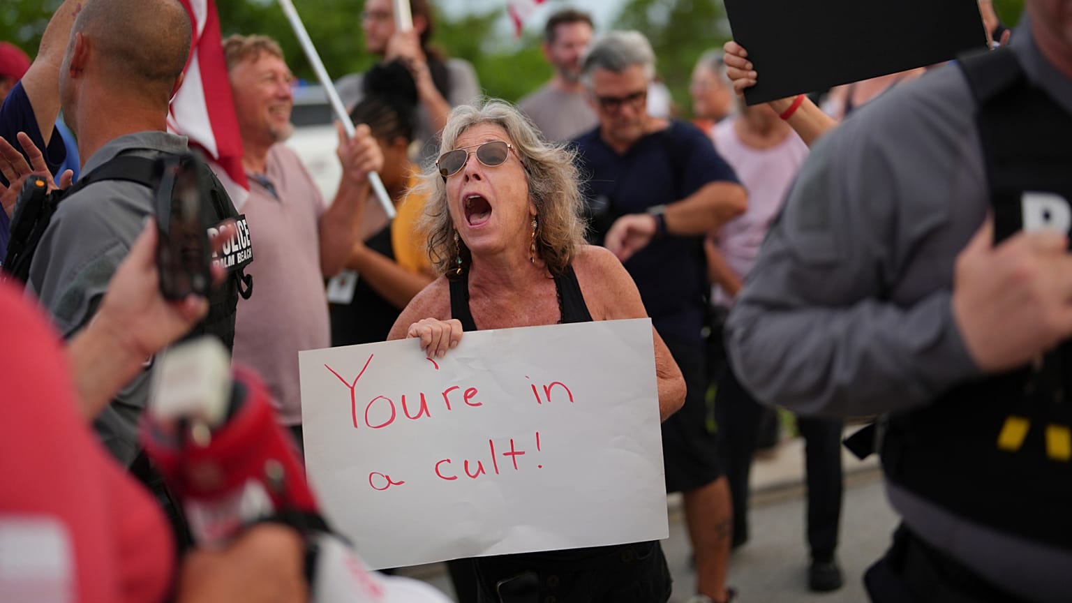 A woman shouts toward supporters of Trump as she participates in a pro-democracy, anti-Trump protest outside Trump's Mar-a-Lago estate in Palm Beach, July 17, 2025.