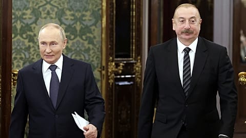 Russian President Vladimir Putin, left, and Azerbaijani President Ilham Aliyev enter a hall during a meeting at the Kremlin in Moscow, Russia, Oct. 8, 2024. 
