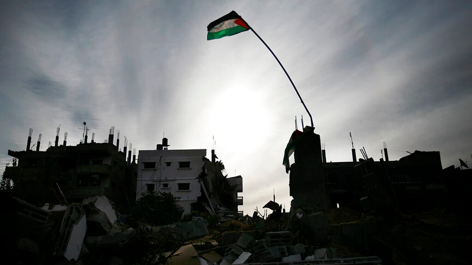 علم فلسطيني يرفرف فوق المباني المدمرة في جباليا ، شمال قطاع غزة