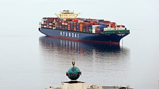 A container ship sits at anchor in Elliott Bay in Seattle.