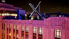 Workers install lighting on an "X" sign atop the company headquarters, formerly known as Twitter, in downtown San Francisco, on Friday, July 28, 2023.