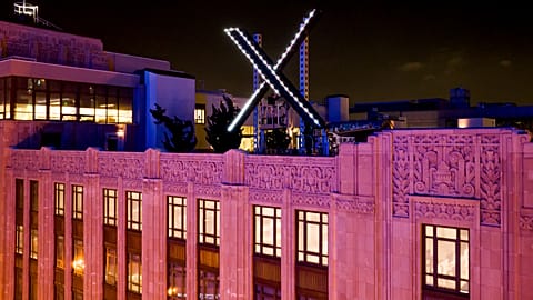 Workers install lighting on an "X" sign atop the company headquarters, formerly known as Twitter, in downtown San Francisco, on Friday, July 28, 2023.