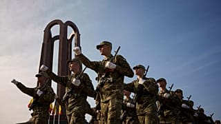 Military students march by the Unknown Soldier monument after a swearing in ceremony on the Romanian Army Day in Bucharest, 25 October, 2023