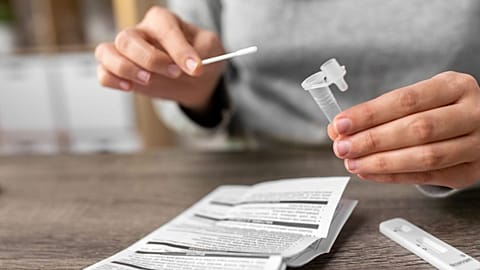 A person uses an at-home test.