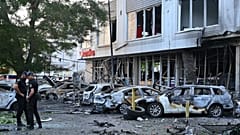 Polizeibeamte inspizieren beschädigte Autos in einem Wohngebiet nach einem russischen Drohnenangriff in Odesa, Ukraine, Dienstag, 22. Juli 2025. 