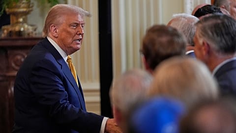 US President Donald Trump greets people during a reception for Republican members of Congress in the East Room of the White House, Tuesday, July 22, 2025, in Washington