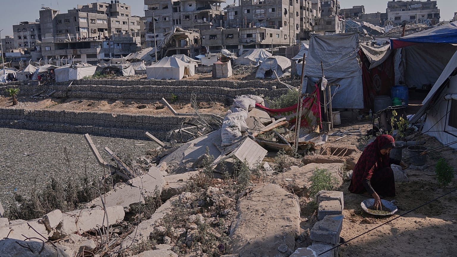 Una mujer planta semillas para cultivar verduras en la ciudad de Gaza, el viernes 18 de julio de 2025.