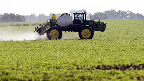 Spraying pesticides on a soya field
