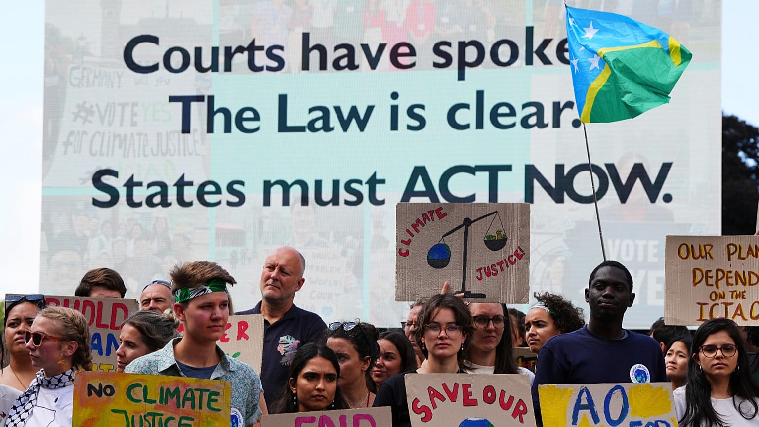 Activists demonstrate outside the International Court of Justice ahead of an advisory opinion.