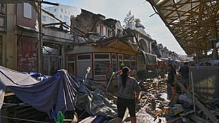 A woman looks at a ruined city market following Russia's drone attack in Odesa, Ukraine, Thursday, July 24, 2025.