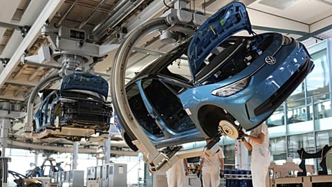 Employees of the German car manufacturer Volkswagen assemble an ID.3 electric car at the transparent factory in Dresden, Germany, Wednesday, May 14, 2025.