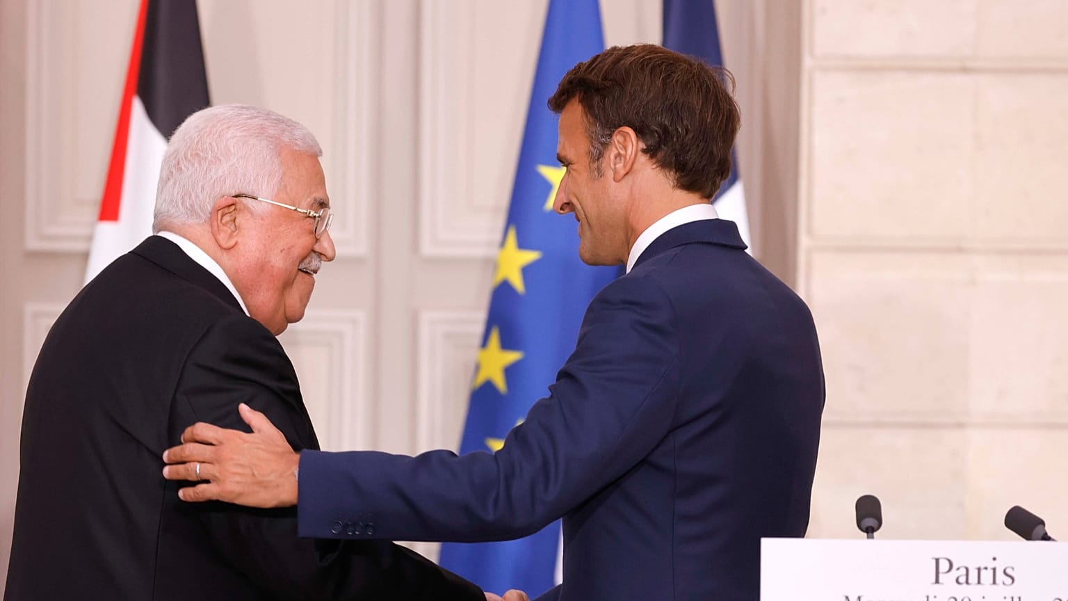Palestinian President Mahmoud Abbas, left, shakes hands with French President Emmanuel Macron during a meeting at the Elysee Palace in Paris, Wednesday, July 20, 2022.