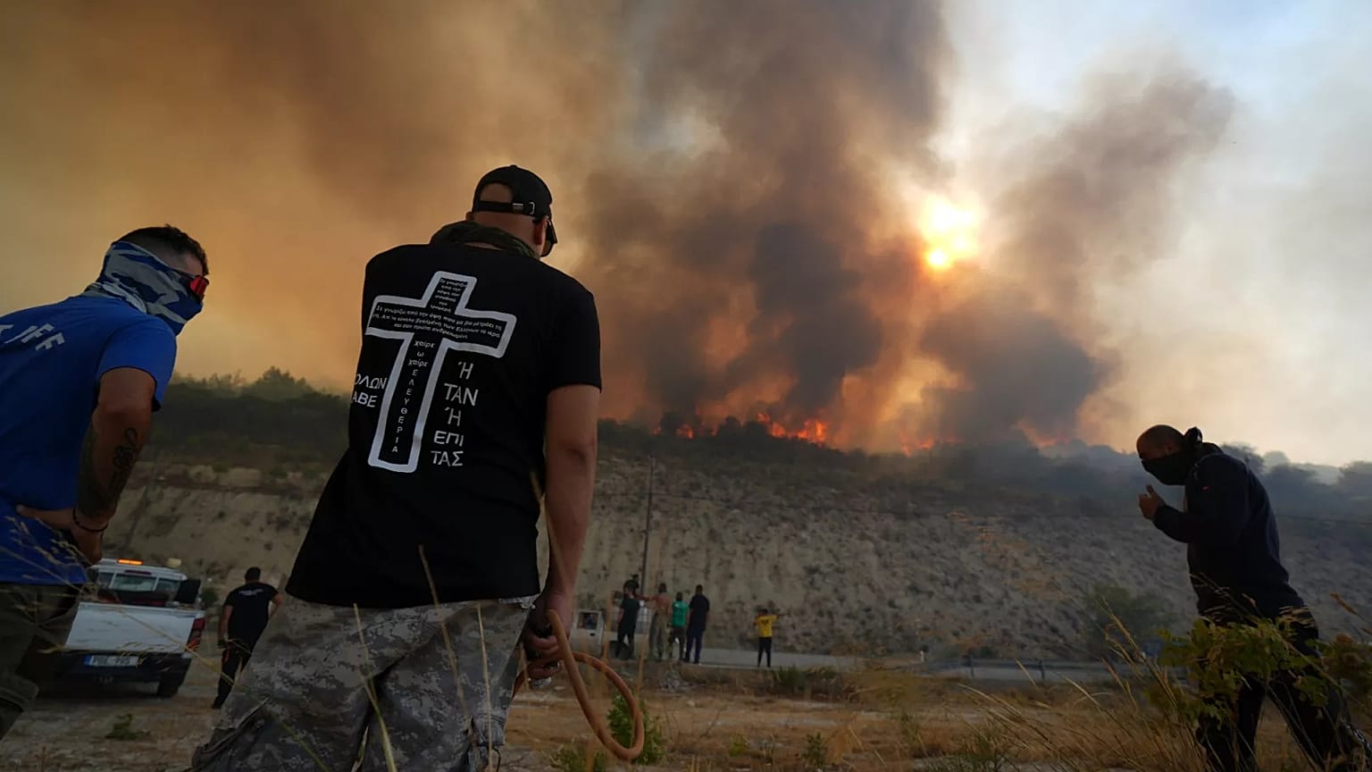 Residents gather to battle the fire at Omodos village, 24 July 2025