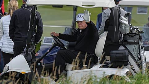 President Donald Trump waves to reporters as he sits in his golf cart at the Trump Turnberry golf course in Turnberry, Scotland, Saturday, July 26, 2025.