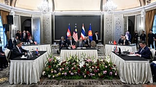 Malaysia's PM Anwar Ibrahim looks on as Cambodia's Hun Manet and Thailand's Phumtham Wechayachai take part in talks on a possible ceasefire, in Putrajaya, 28 July 2025