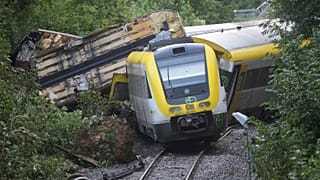 Wagons of a derailed regional passenger train in Germany