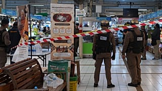 Policemen of a special operations unit at a crime scene at a market in Bangkok, 28 July 2025
