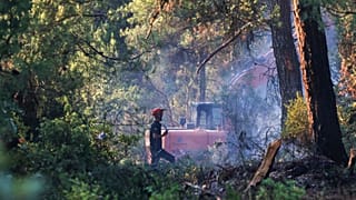 Firefighters work to extinguish a wildfire in Bursa, Turkey, 27 July 2025.