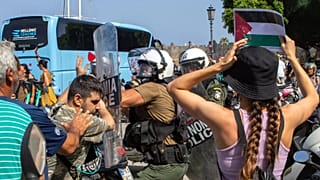 Riot police scuffle with pro-Palestinian protesters during the departure of a cruise ship carrying Israeli tourists on the southeastern Aegean Sea island of Rhodes, 28 July, 2
