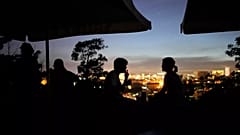 People sit on the terrace of a closed bar at the Monte Agudo viewpoint overlooking Lisbon during a nationwide power outage, 28 April, 2025