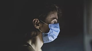 امرأة تضع قناعًا واقيًا على وجهها
