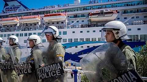 Riot police stand guard during the arrival of a ship carrying Israeli tourists on the island of Crete, 29 July, 2025
