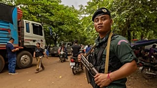An armed Cambodian National Police officer protects a supply truck at a resettlement camp in Oddar Meanchey, 27 July, 2025