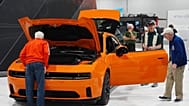 FILE - Shoppers look over a 2025 Dodge Charger Daytona hardtop in the Stellantis display at the Colorado Auto Show on 17 April 2025, in Denver.