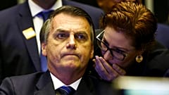 O então presidente do Brasil, Jair Bolsonaro, ouve Carla Zambelli sussurrar ao seu ouvido durante uma reunião do Congresso, em Brasília, Brasil, 29 de maio de 2019