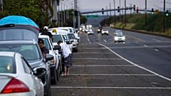 Oahu residents evacuate Ewa Beach to the side of Kunia Road due to the threat of tsunami in Kapolei, Oahu, Hawaii, Tuesday, July 29.