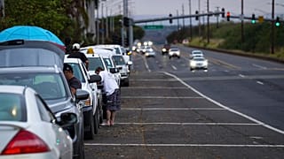 Oahu residents evacuate Ewa Beach to the side of Kunia Road due to the threat of tsunami in Kapolei, Oahu, Hawaii, Tuesday, July 29.