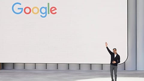 Alphabet CEO Sundar Pichai waves after speaking at a Google I/O event.