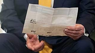 US President Donald Trump holds a document during the conclusion of the trade agreement with the EU, in Turnberry, Scotland, Sunday 27 July 2025.