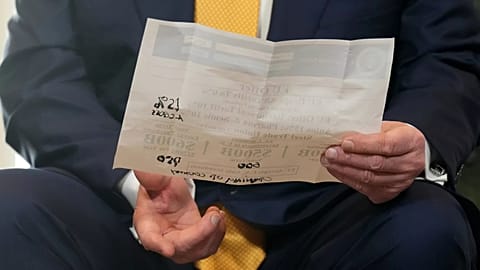 US President Donald Trump holds a document during the conclusion of the trade agreement with the EU, in Turnberry, Scotland, Sunday 27 July 2025.