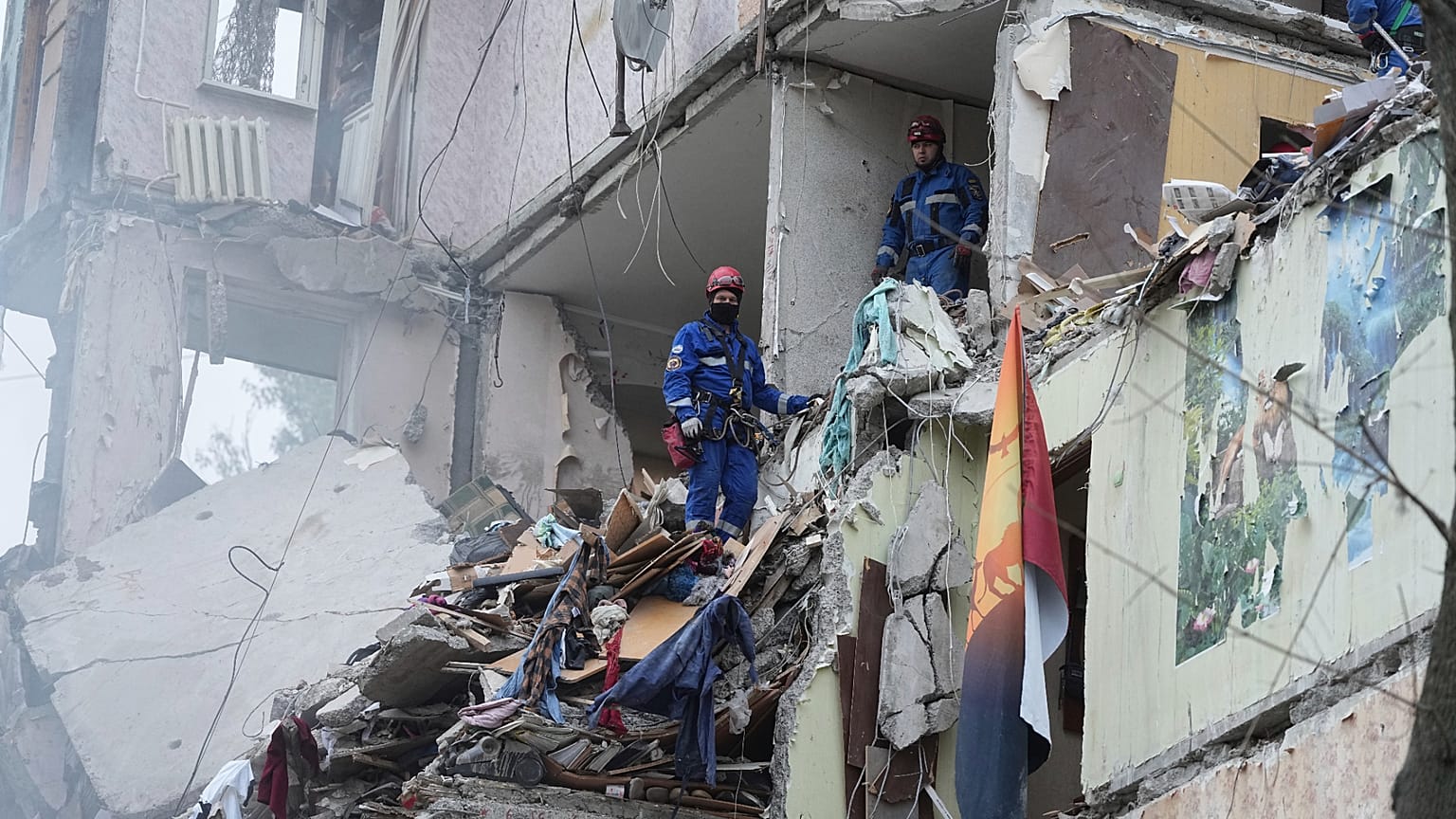 Rescuers work in a destroyed apartment building after a Russian missile attack in Kyiv, 31 July 2025