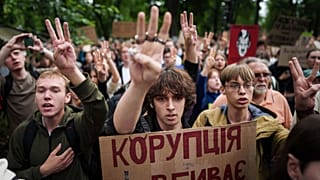 Participants gather at a protest against a law targeting anti-corruption institutions in front of the Ukrainian parliament in Kyiv, 31 July, 2025
