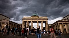 DATEI: Menschen besuchen das Brandenburger Tor in Berlin, Deutschland, Dienstag, 15. Juli 2025.
