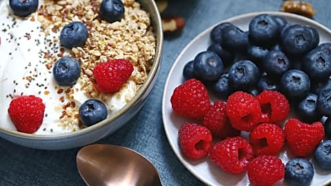 A bowl of yoghurt and berries is shown.