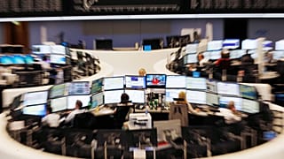 A curve of the German stock index DAX, top, is displayed on a board at the stock market in Frankfurt, Germany. 29 June 2015.