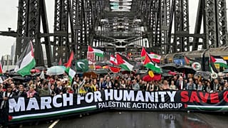 Thousands of protesters walk across the Sydney Harbour Bridge during the Palestine Action Group's March for Humanity in Sydney, Sunday, August 3, 2025.