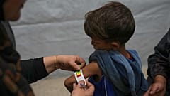 Samah Matar poses with her 6-year-old son Yousef, who suffers from malnutrition and cerebral palsy, at a U.N.-run school in Gaza City on 26 July 2025.
