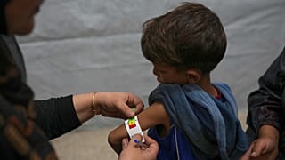 Samah Matar poses with her 6-year-old son Yousef, who suffers from malnutrition and cerebral palsy, at a U.N.-run school in Gaza City on 26 July 2025.