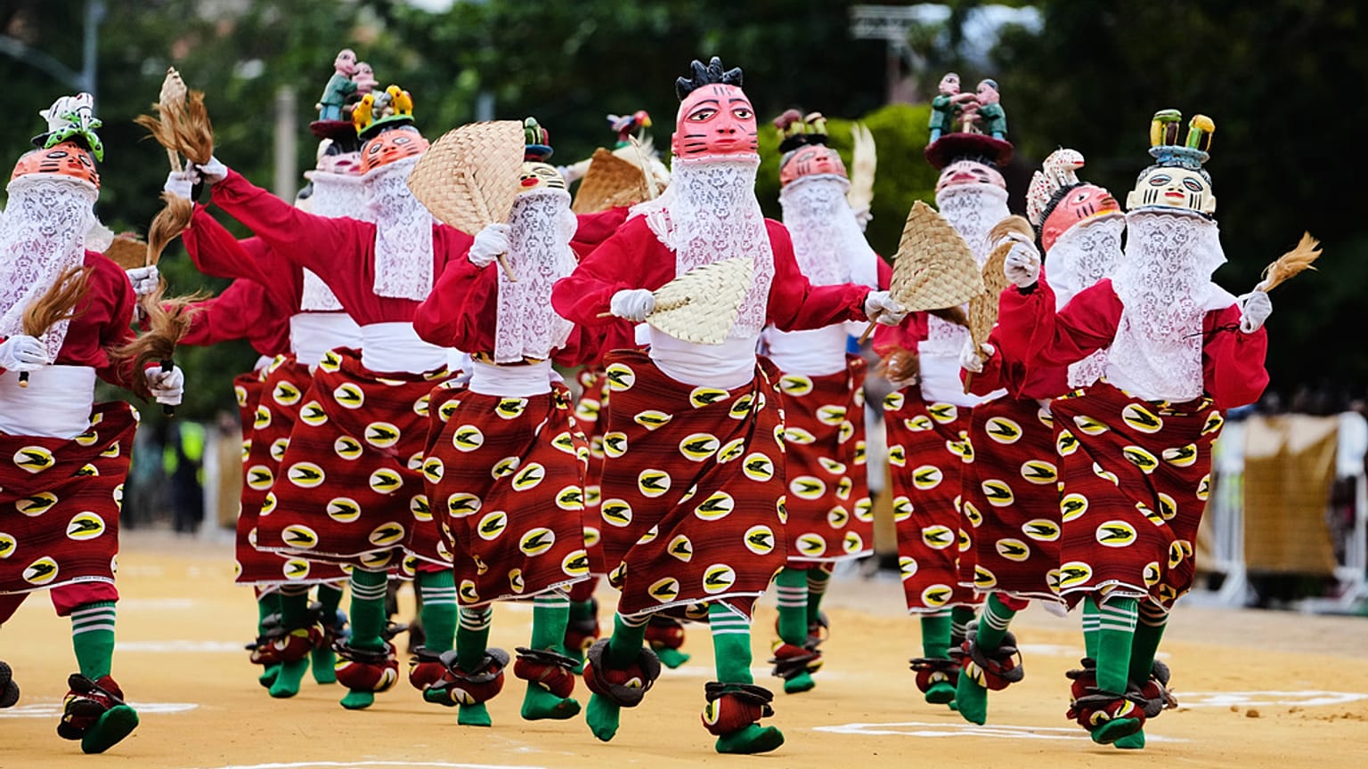 eople dressed in costumes perform during the mask festival in Porto-Novo, Benin.