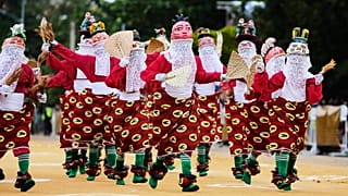 eople dressed in costumes perform during the mask festival in Porto-Novo, Benin.