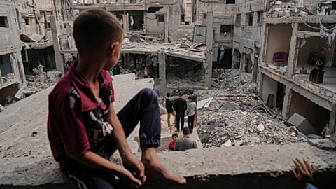 FILE PHOTO - Palestinians inspect the rubble of the Al-Lahham family's home, destroyed by Israeli airstrikes in Khan Younis, Gaza Strip, on Thursday, May 15, 2025.