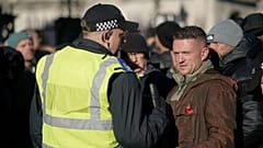 FILE: Far-right figurehead Tommy Robinson speaks to a police officer in London, 11 November 2023