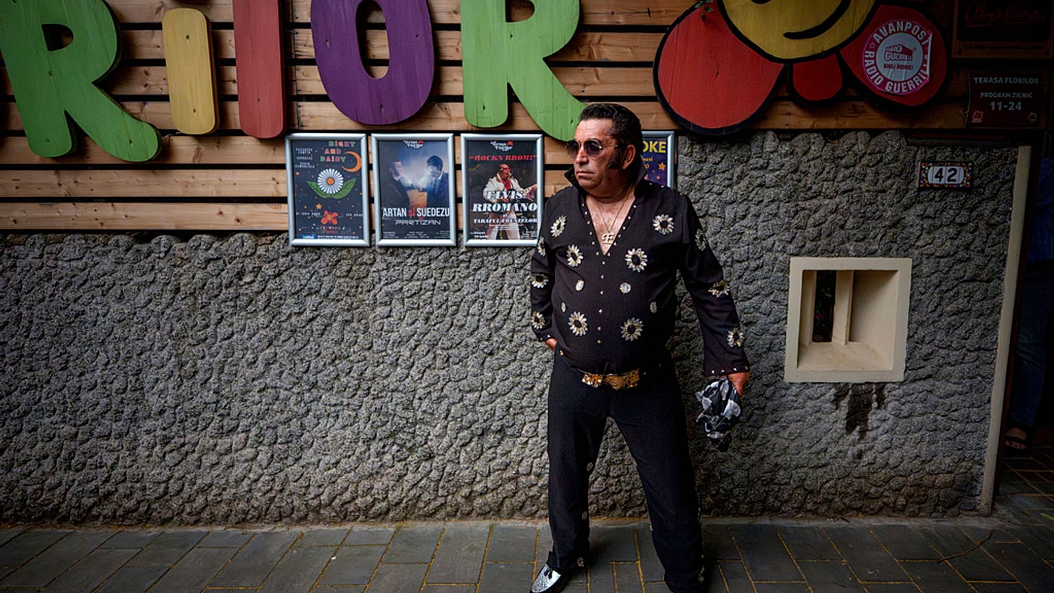 Tudor Lakatos, who goes by the stage name Elvis Rromano, poses outside the Terasa Florilor restaurant before a performance in Bucharest