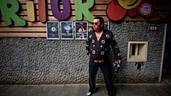 Tudor Lakatos, who goes by the stage name Elvis Rromano, poses outside the Terasa Florilor restaurant before a performance in Bucharest