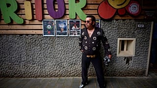 Tudor Lakatos, who goes by the stage name Elvis Rromano, poses outside the Terasa Florilor restaurant before a performance in Bucharest